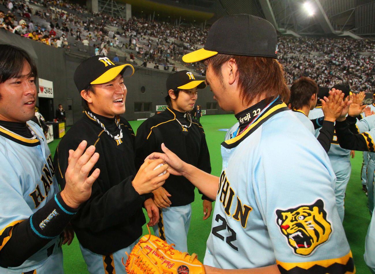 10年5月29日、日本ハム戦で初勝利を挙げた鶴（左）は、藤川から勝利球を受け取る
