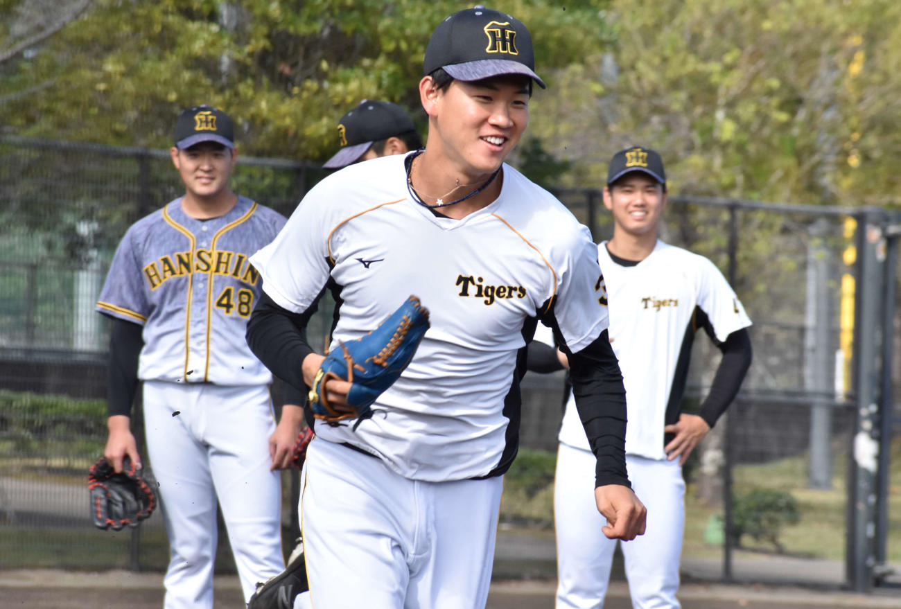 フェニックス・リーグのロッテ戦に先発する阪神及川は試合前に笑顔で体を動かす（撮影・只松憲）