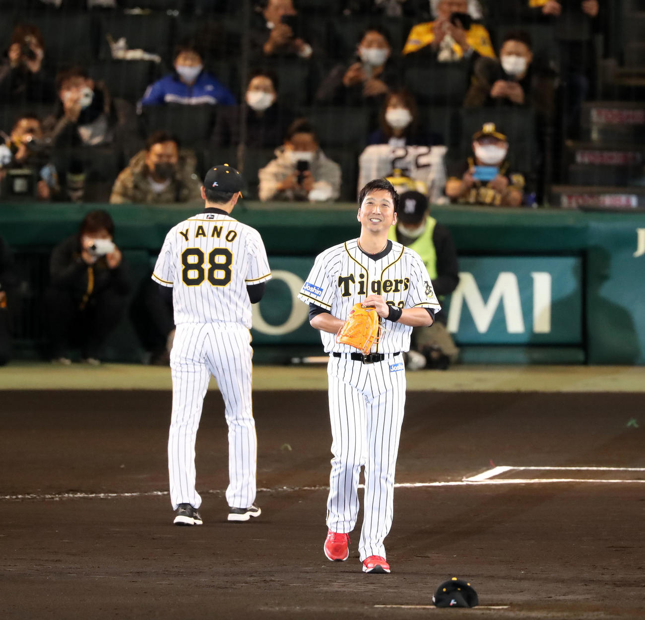 阪神対巨人　引退セレモニーで藤川球児（右）は矢野燿大監督からグラブを手渡されマウンドへ向かう（撮影・加藤哉）