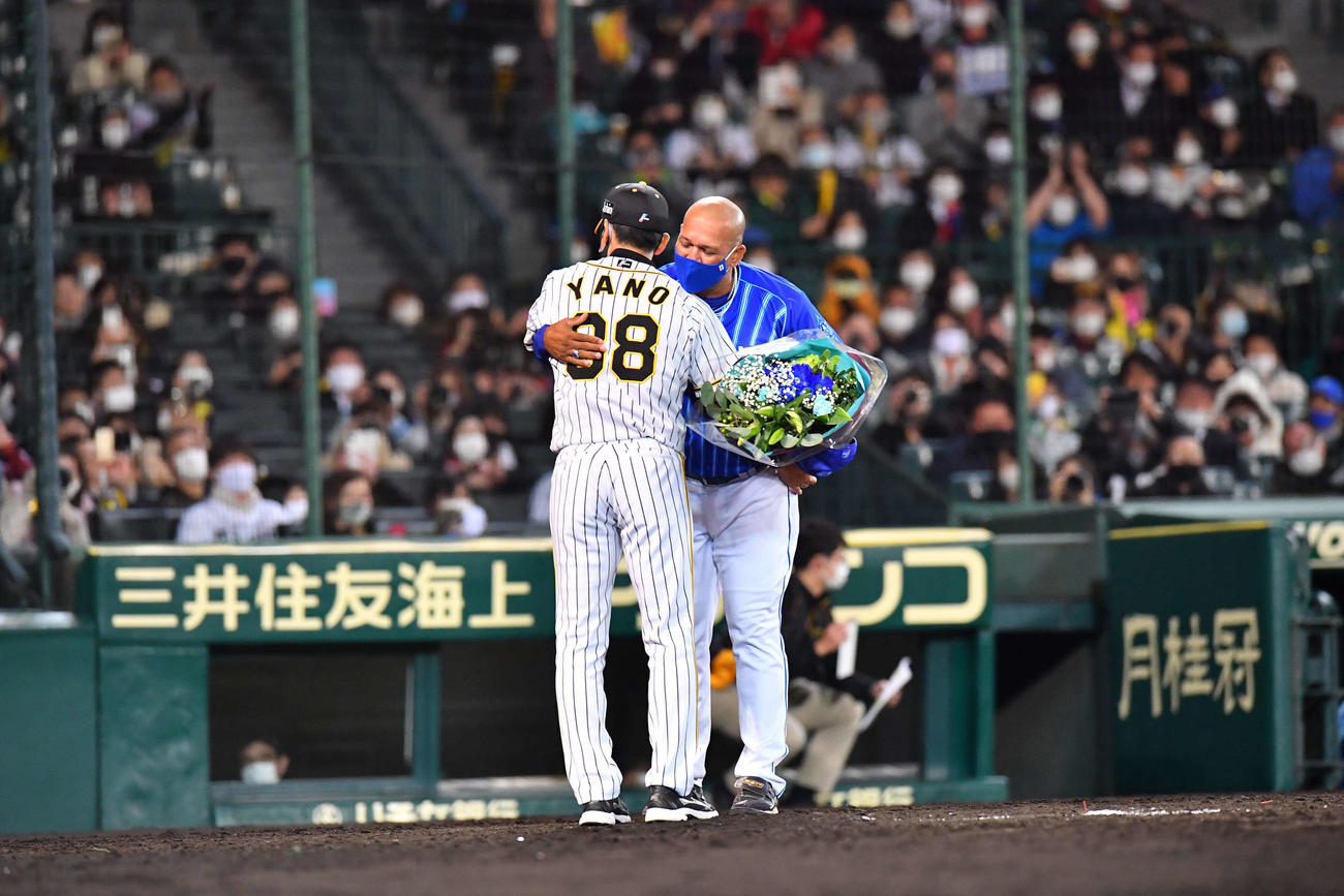 阪神対DeNA　矢野燿大監督から花束を受け取り抱擁するアレックス・ラミレス監督（撮影・上田博志）