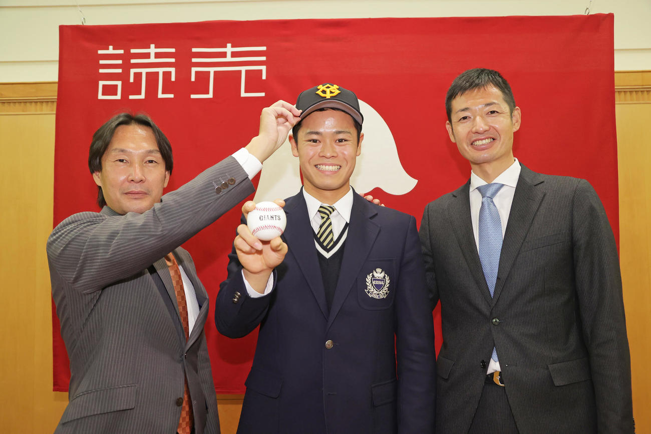 巨人と仮契約を結び笑顔を見せる中京大中京・中山礼都（中央）と榑松スカウト部次長（左）、青木スカウト（球団提供）