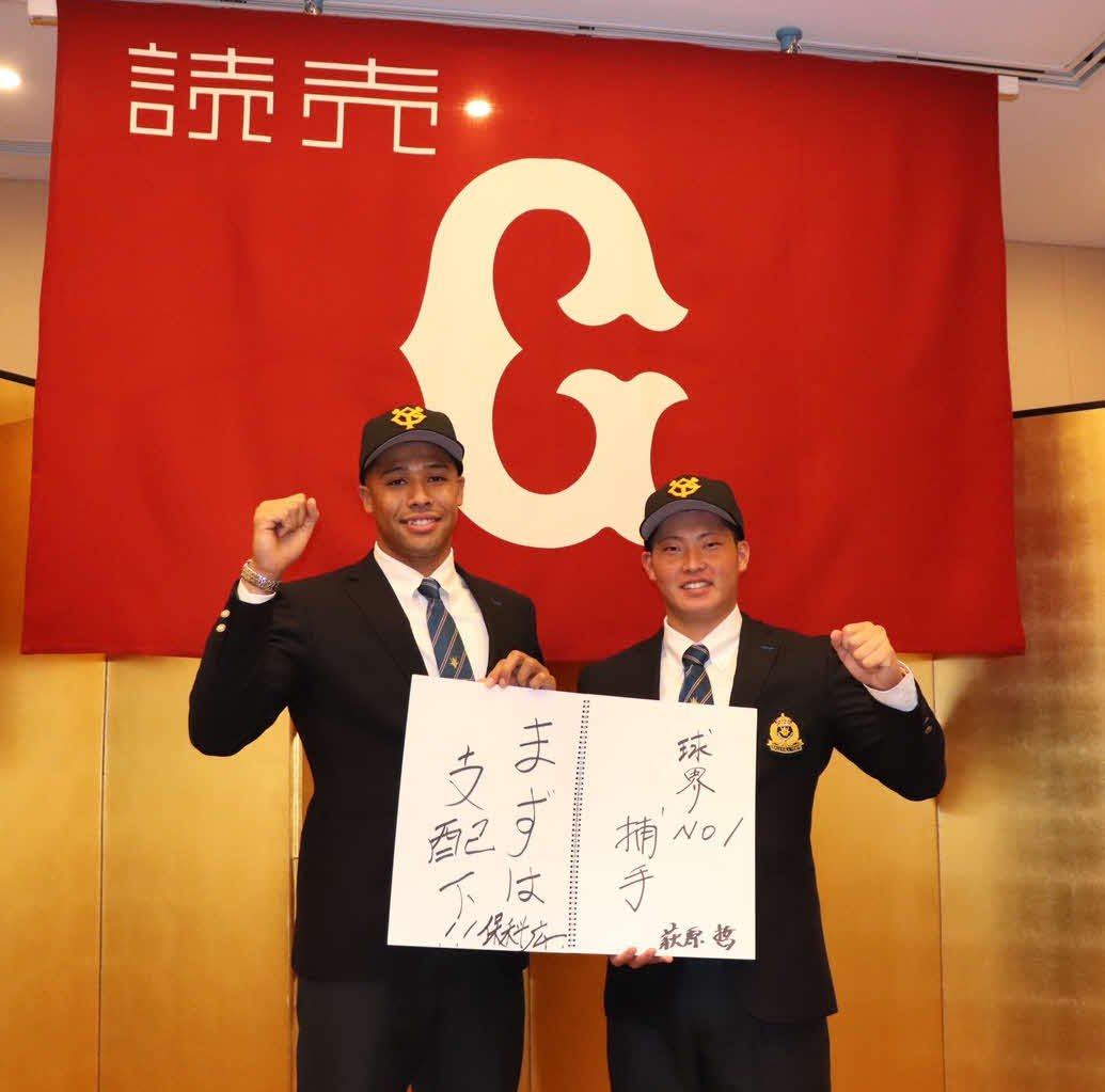仮契約を結び、ポーズを決める巨人ドラフト7位創価大・萩原（右）と育成11位の保科（撮影・久永壮真）