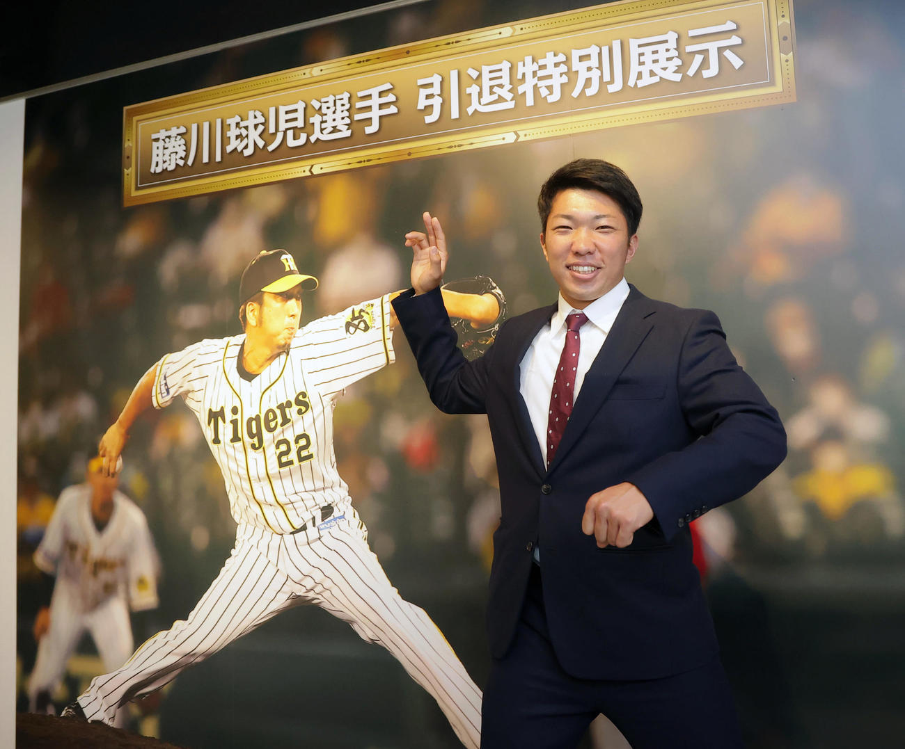 甲子園歴史館を見学し、元阪神の藤川氏の展示品の前でポーズをとる石井（代表撮影）