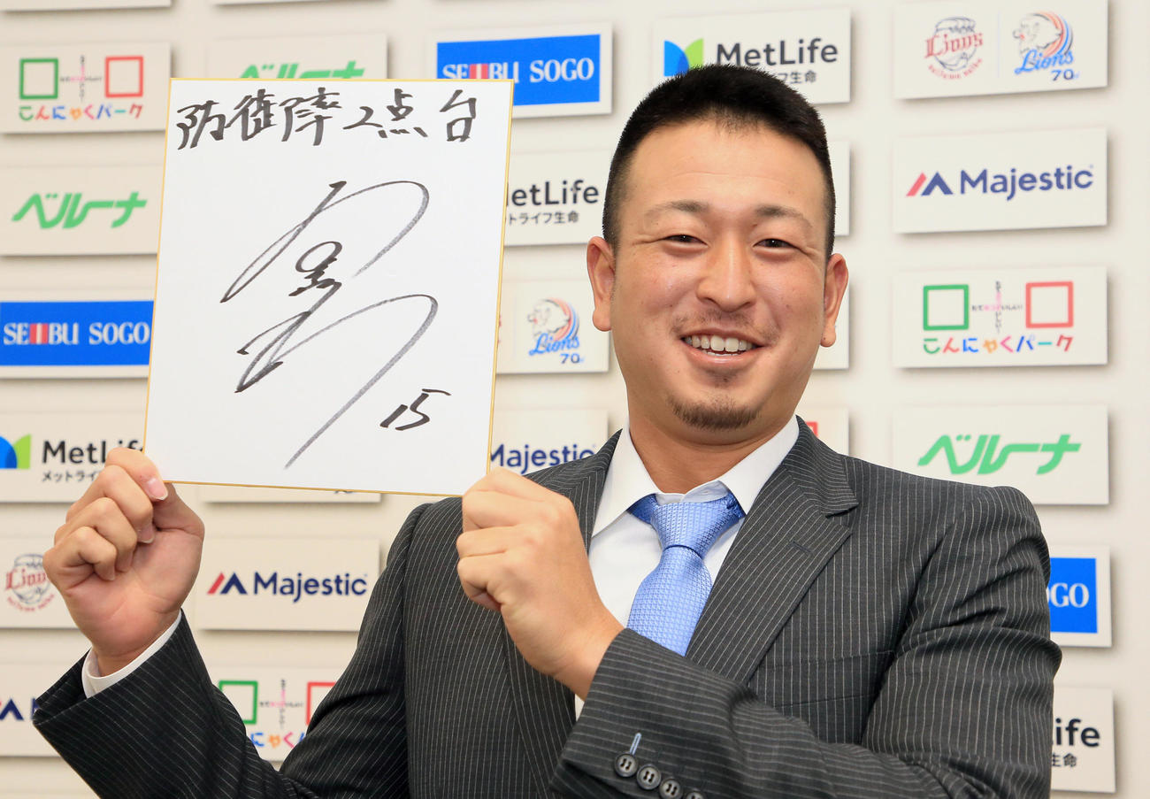来年の目標を記した色紙を手に笑顔を見せる西武宮川（代表撮影）