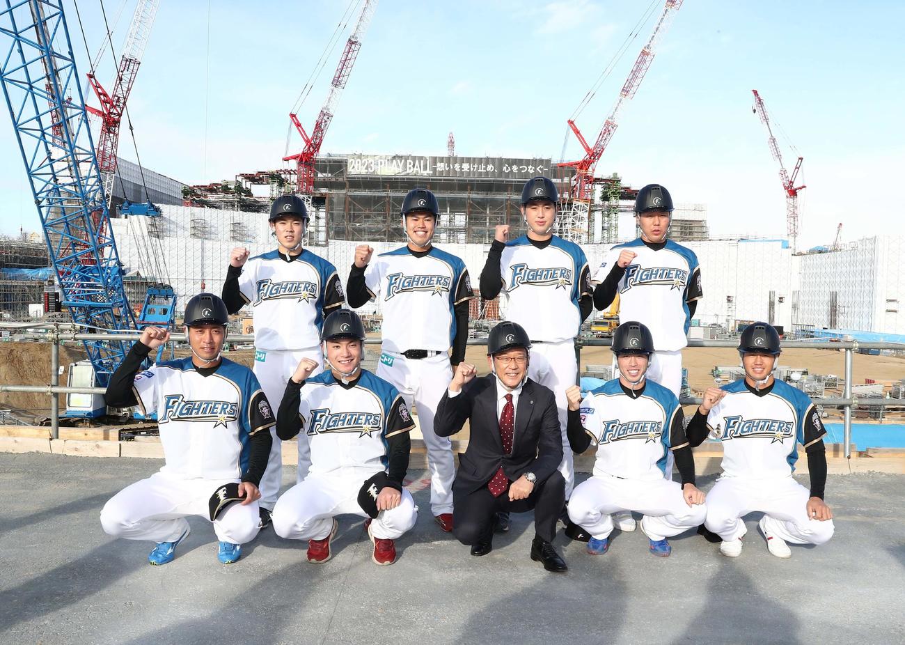 建設中の新球場を背に意気込む日本ハムの新入団選手たち。前列左から、3位古川、1位伊藤、栗山監督、2位五十幡、4位細川、後列左から5位根本、6位今川、育成1位松本遼、育成2位斉藤（撮影・黒川智章）