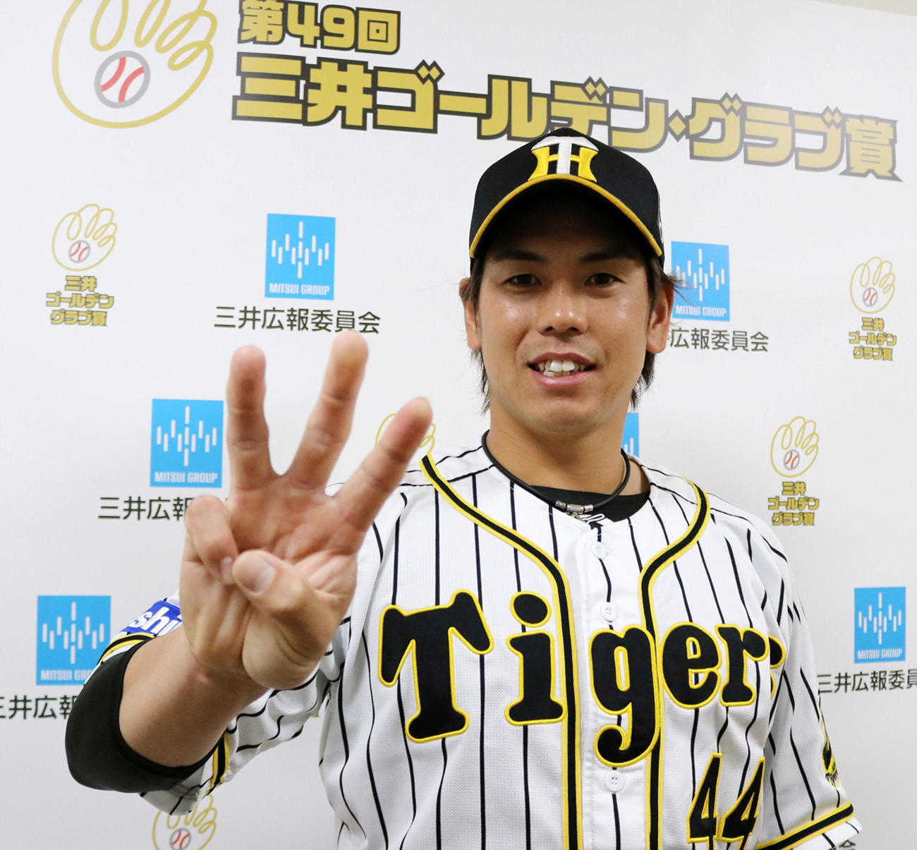 ゴールデングラブ賞を受賞し笑顔でポーズを決める梅野（球団提供）