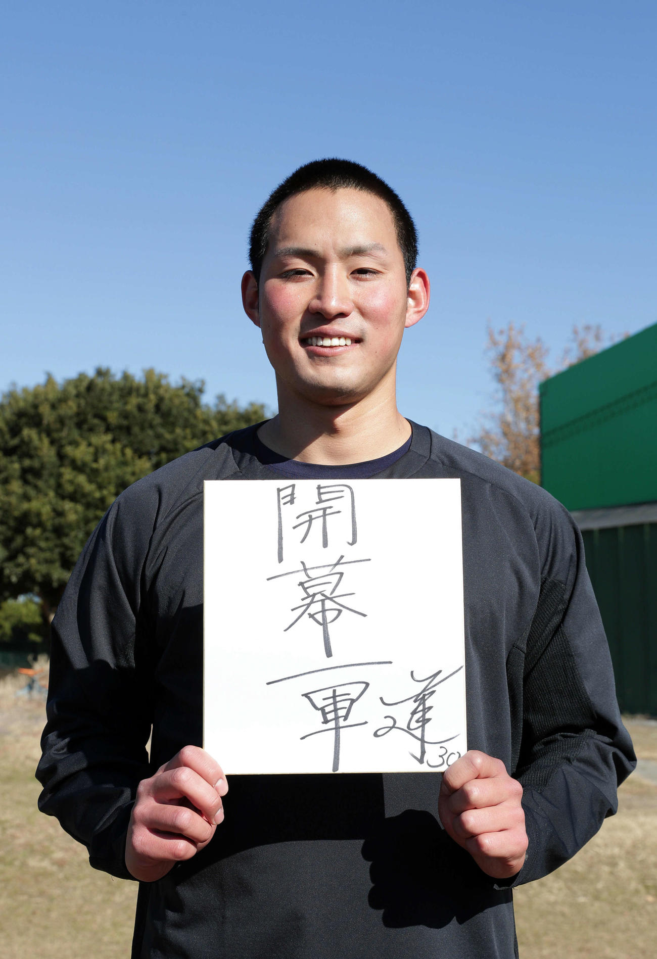 自主トレを公開した阪神佐藤蓮は「開幕一軍」と記した色紙を手に笑顔を見せる（撮影・前田充）