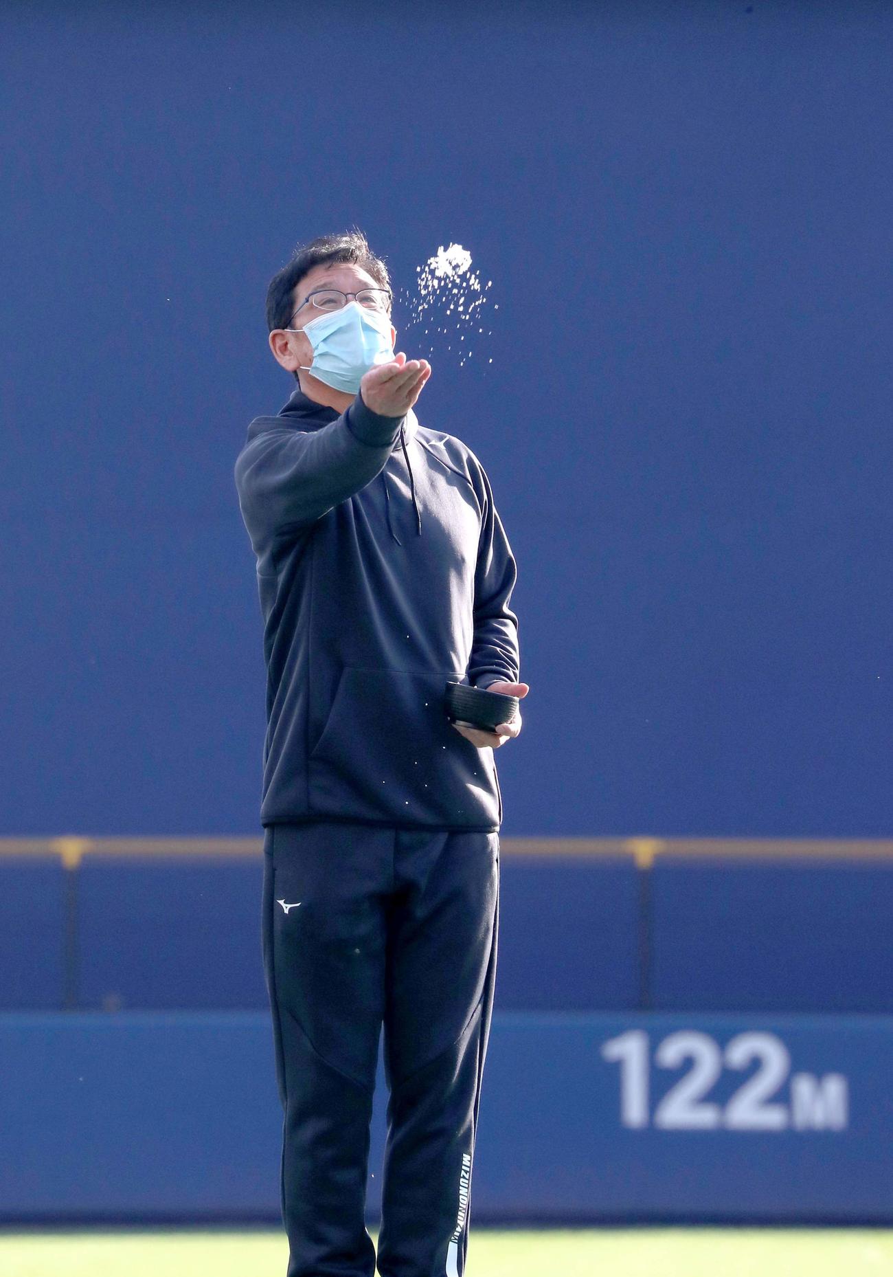 タピックスタジアム名護のグラウンドに塩をまく日本ハム栗山監督（撮影・佐藤翔太）