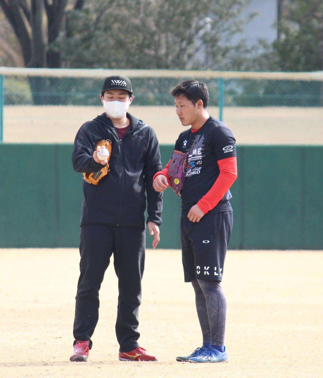 尾林投手（右）と変化球の握りについて話すBC・埼玉に新加入した由規投手（左）（撮影・保坂恭子）