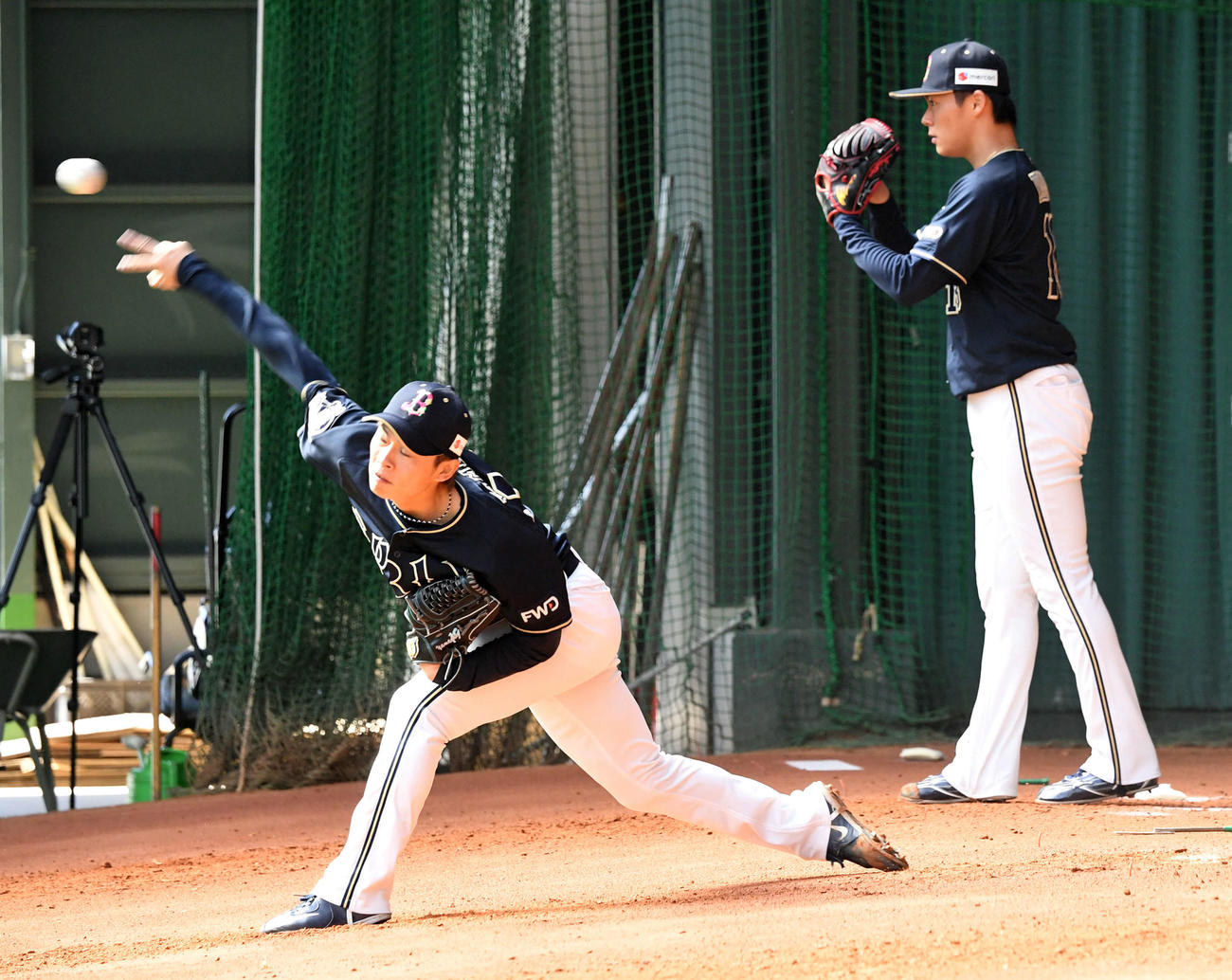 ブルペンに並んで投球練習を行うオリックス山岡（左）と山本（撮影・前岡正明）