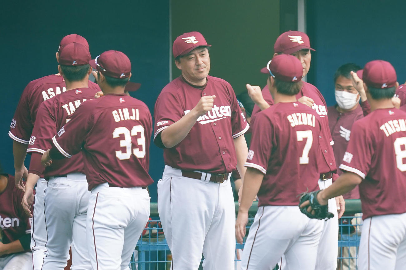 ヤクルトとの練習試合に勝利し、ナインを出迎える石井GМ兼監督（中央）（撮影・菅敏）