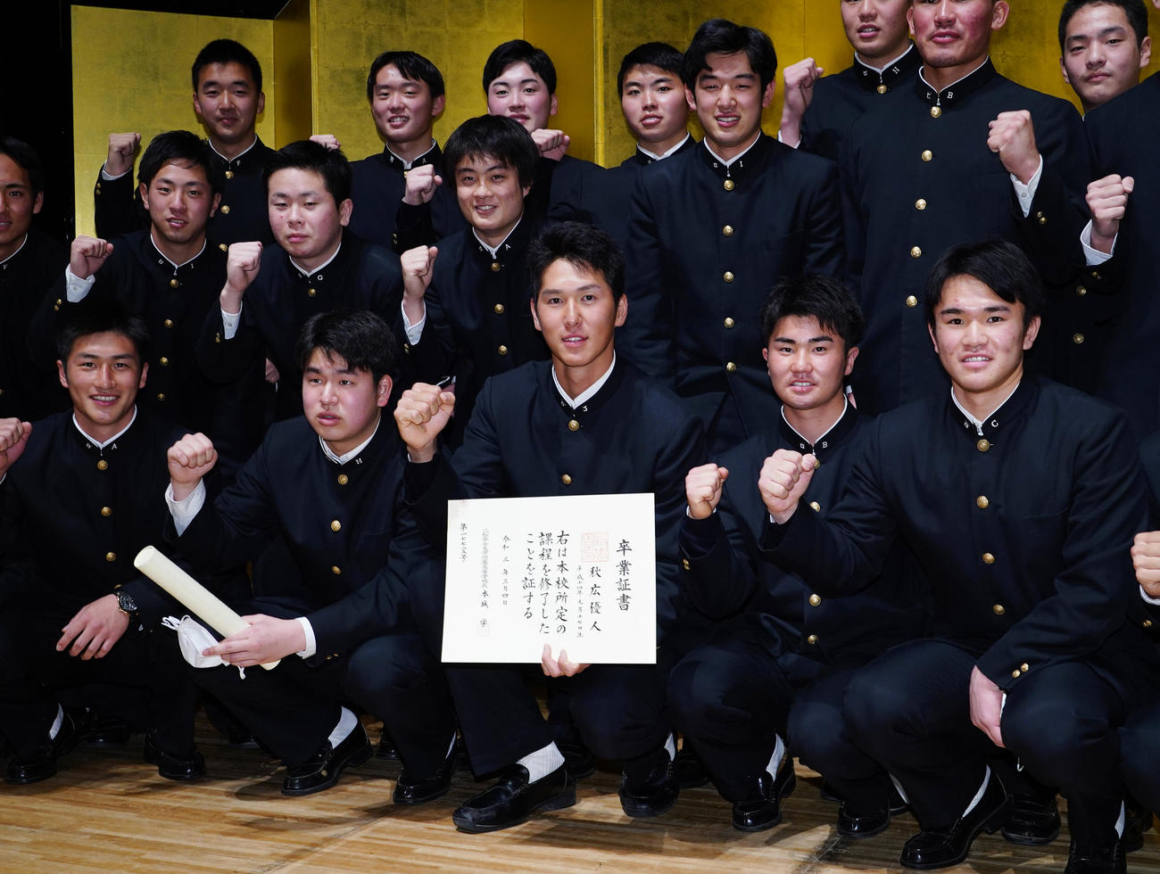 二松学舎大付高の卒業式を終え、チームメートと記念写真に納まる巨人秋広（中央）（撮影・菅敏）