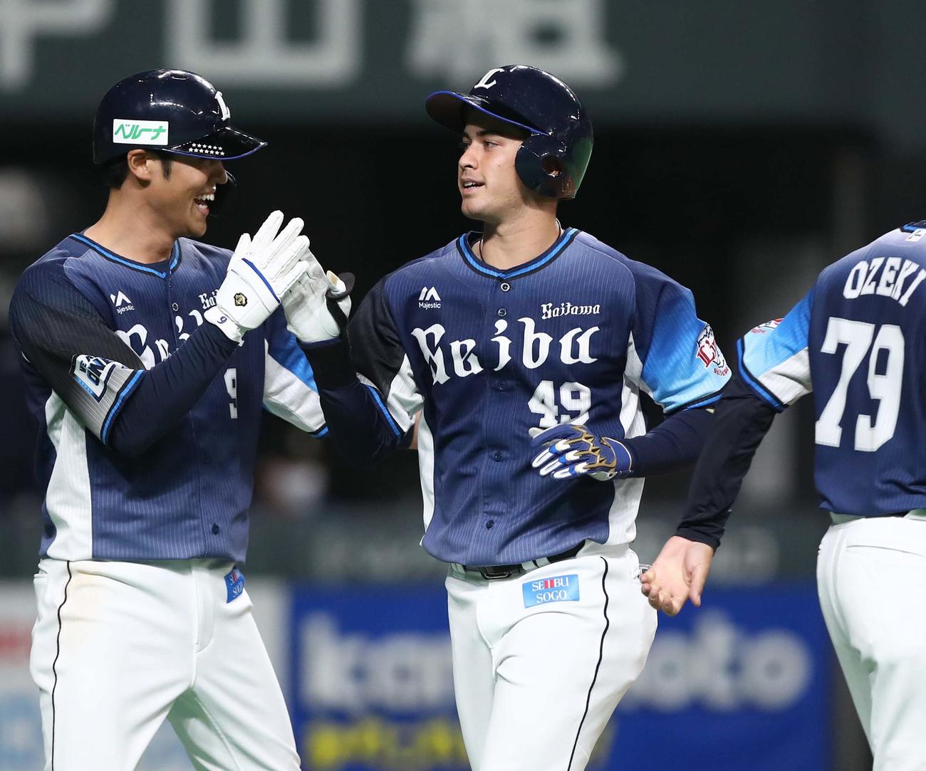 日本ハム対西武　2回表西武1死一塁、左越え2点本塁打を放ち木村（左）に出迎えられるブランドン（撮影・黒川智章）