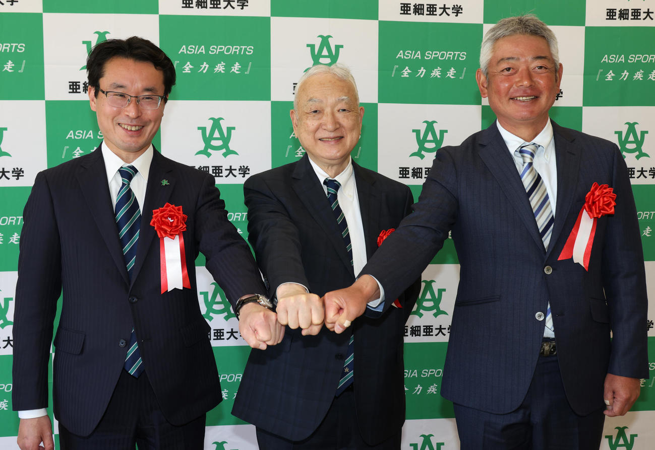 亜大硬式野球部日の出寮の竣工（しゅんこう）式を終え笑顔で手を合わせる（左）から小川直之野球部長、大島正克亜大学長、生田勉野球部監督（撮影・中島郁夫）