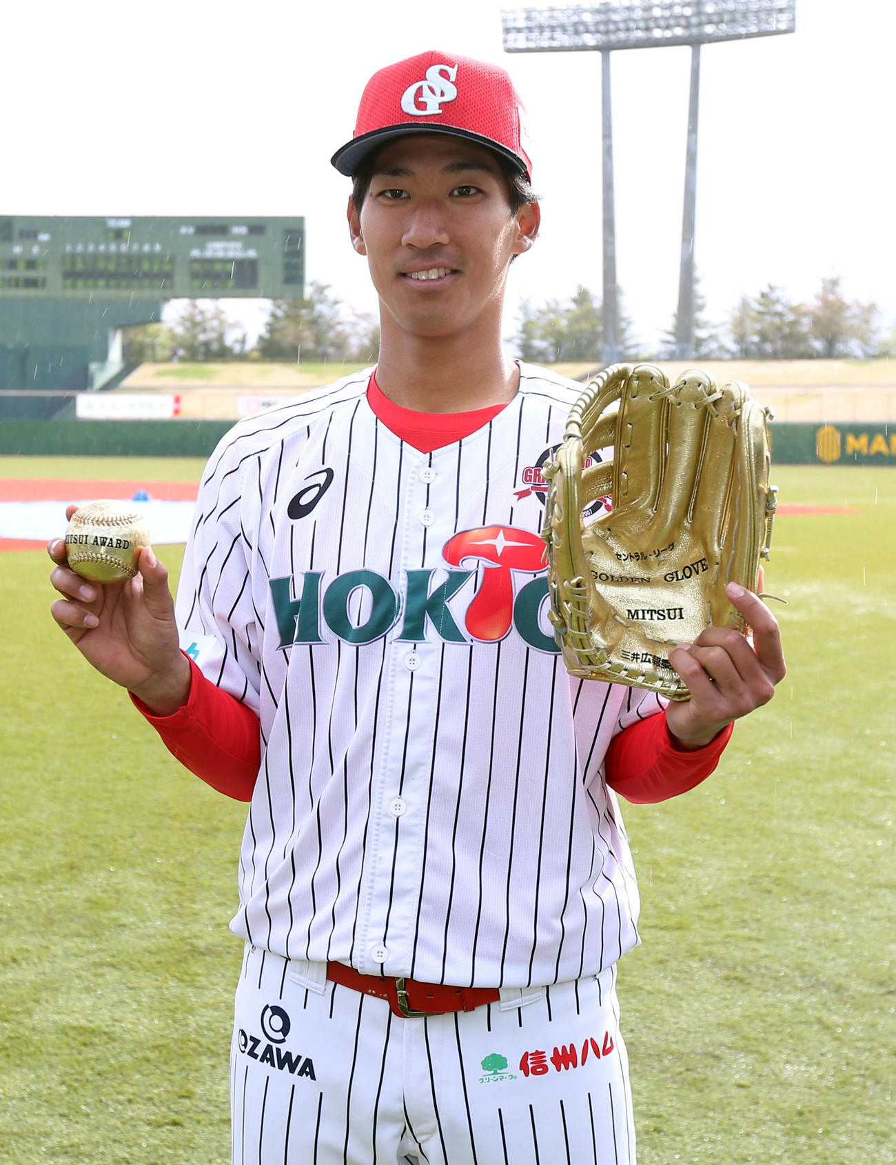 BC信濃対BC新潟　試合に勝利し、新庄氏のゴールデングラブを手に記念撮影するBC信濃の新井（撮影・狩俣裕三）