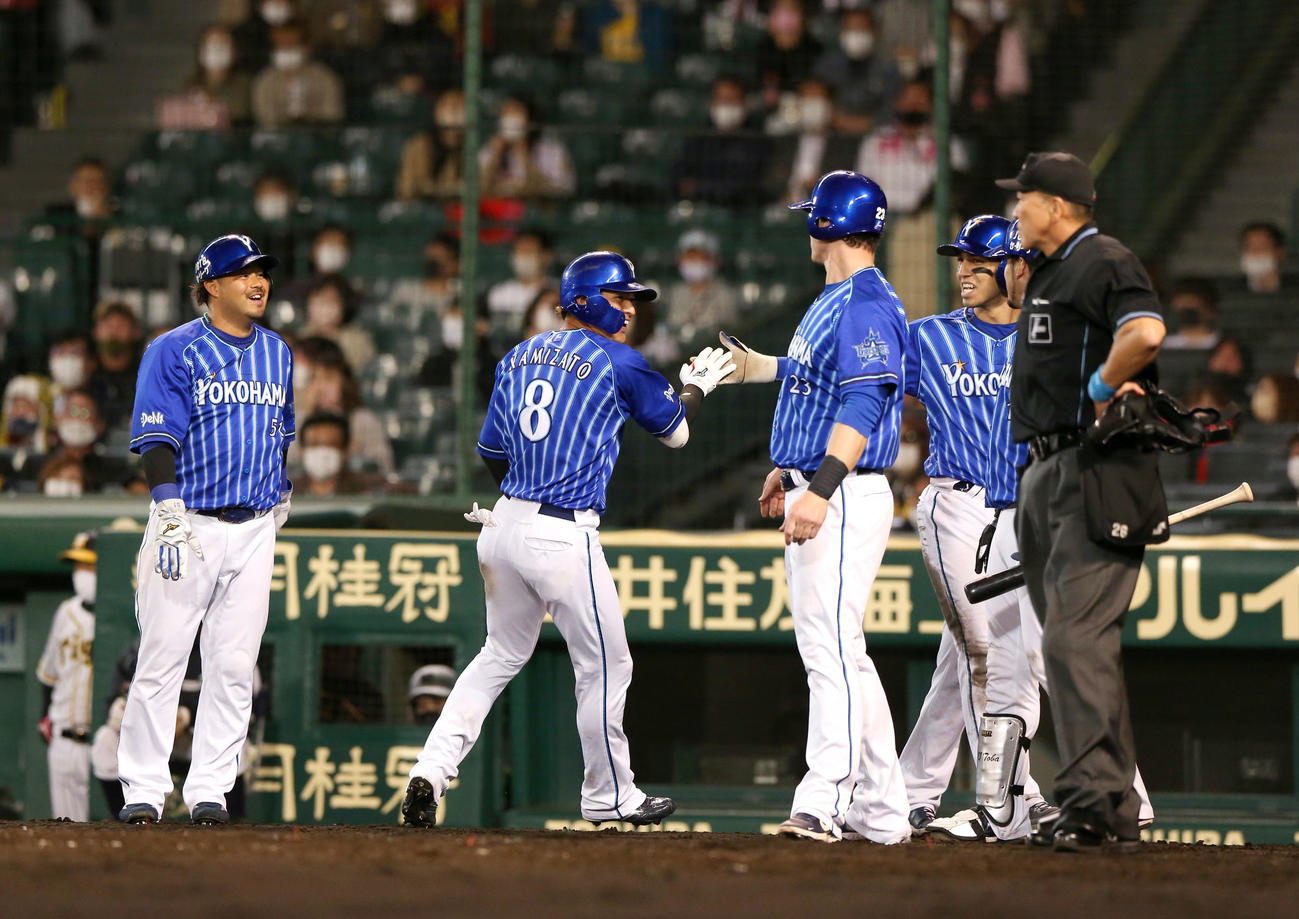 阪神対DeNA 5回表DeNA1死満塁、神里（左から2人目）は右に満塁ランニング本塁打を放ち出迎えに笑顔を見せる（撮影・上山淳一）