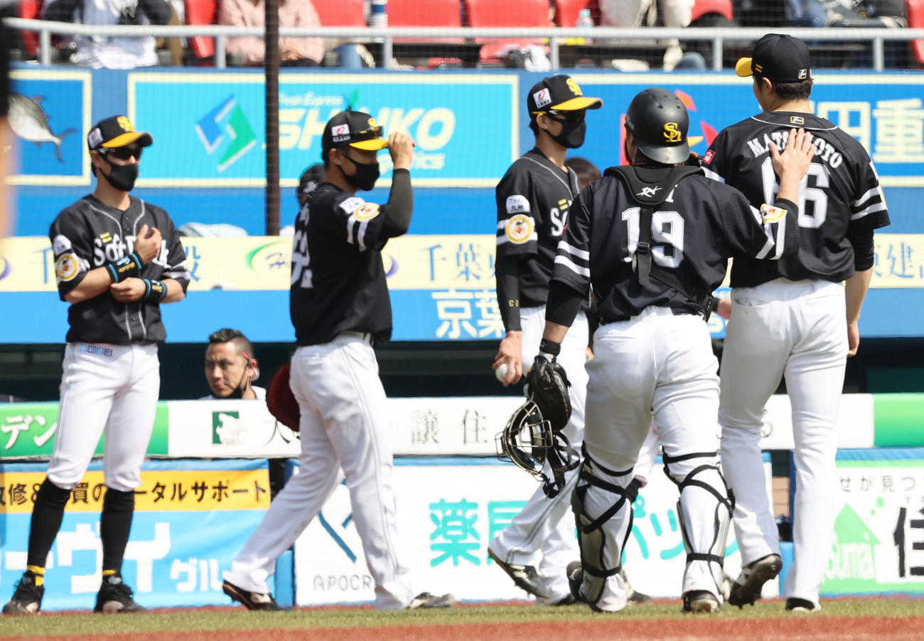 ロッテ対ソフトバンク　4回裏の登板を終えたソフトバンク先発の松本（右端）の背中をたたき励ます甲斐（同2人目）（撮影・垰建太）