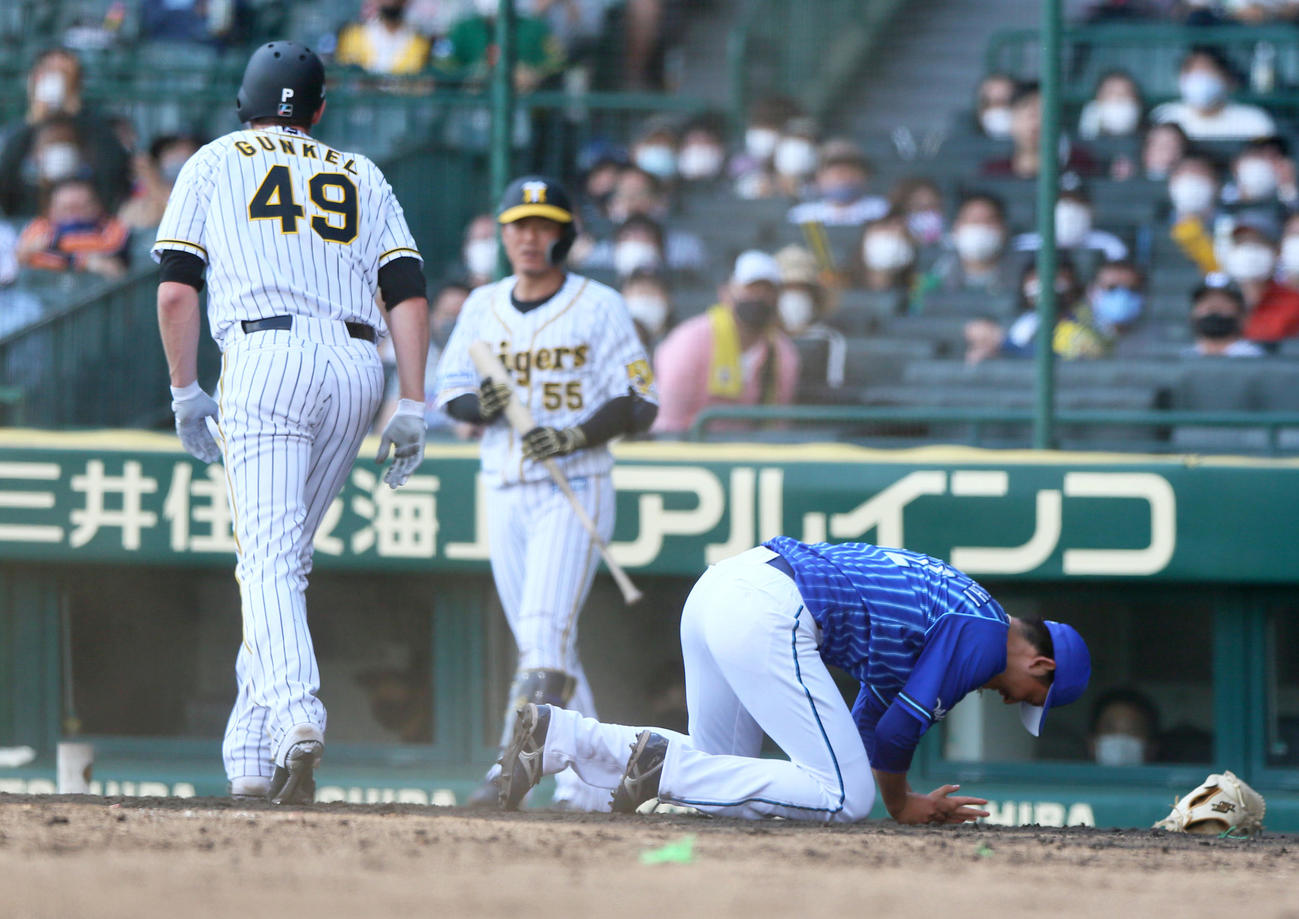 阪神対DeNA 5回裏阪神1死三塁、阪口（右）は暴投し、生還のガンケル（手前）と本塁で激突しうずくまる（撮影・上山淳一）