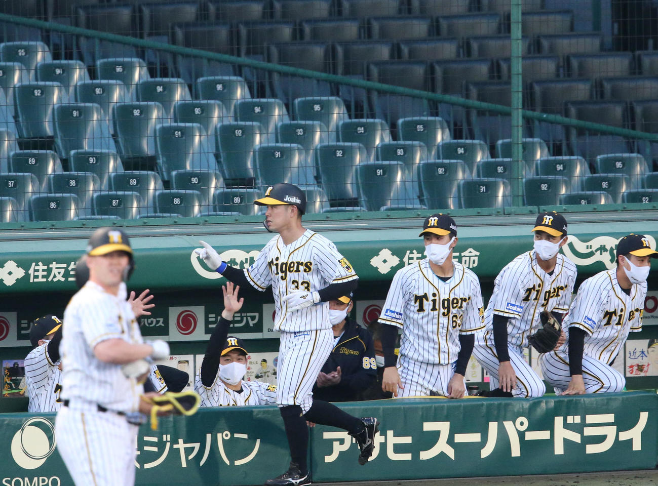 阪神対広島　1回裏阪神2死一、二塁、サンズ（手前左）の左前適時打で先制生還の糸原を出迎える阪神ベンチ（撮影・上山淳一）