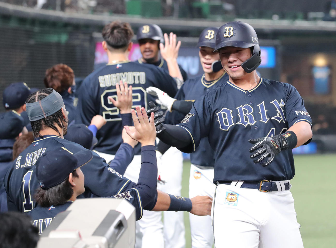 西武対オリックス　6回表オリックス無死一、二塁、3点本塁打を放ち宮城（手前左）とタッチを交わす頓宮（右）（撮影・垰建太）