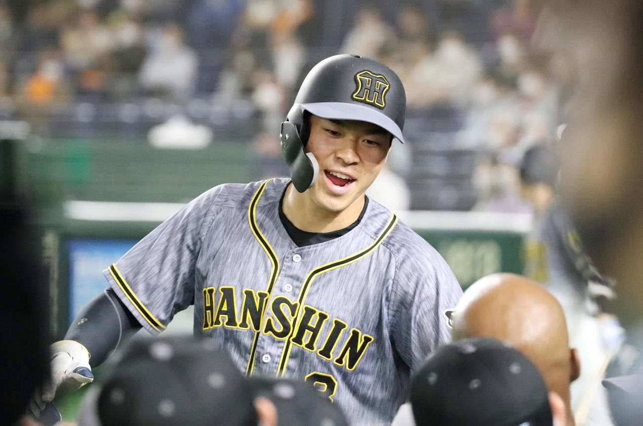 巨人対阪神　4回表阪神2死一、三塁、三塁走者佐藤輝は梅野の中前適時打で生還し笑顔でナインとエアタッチする（撮影・加藤哉）