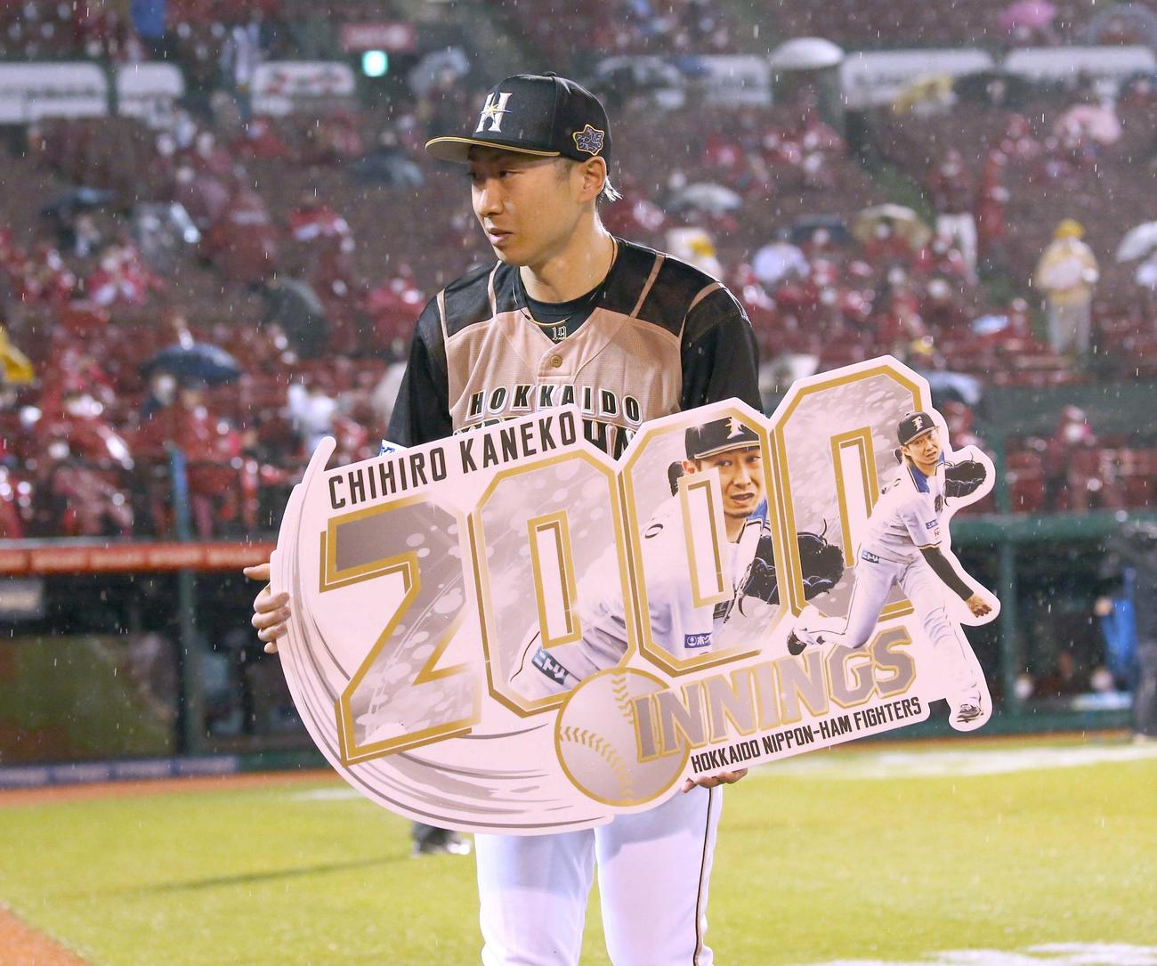 楽天対日本ハム　通算2000投球回を達成し記念ボードを掲げる金子（撮影・黒川智章）