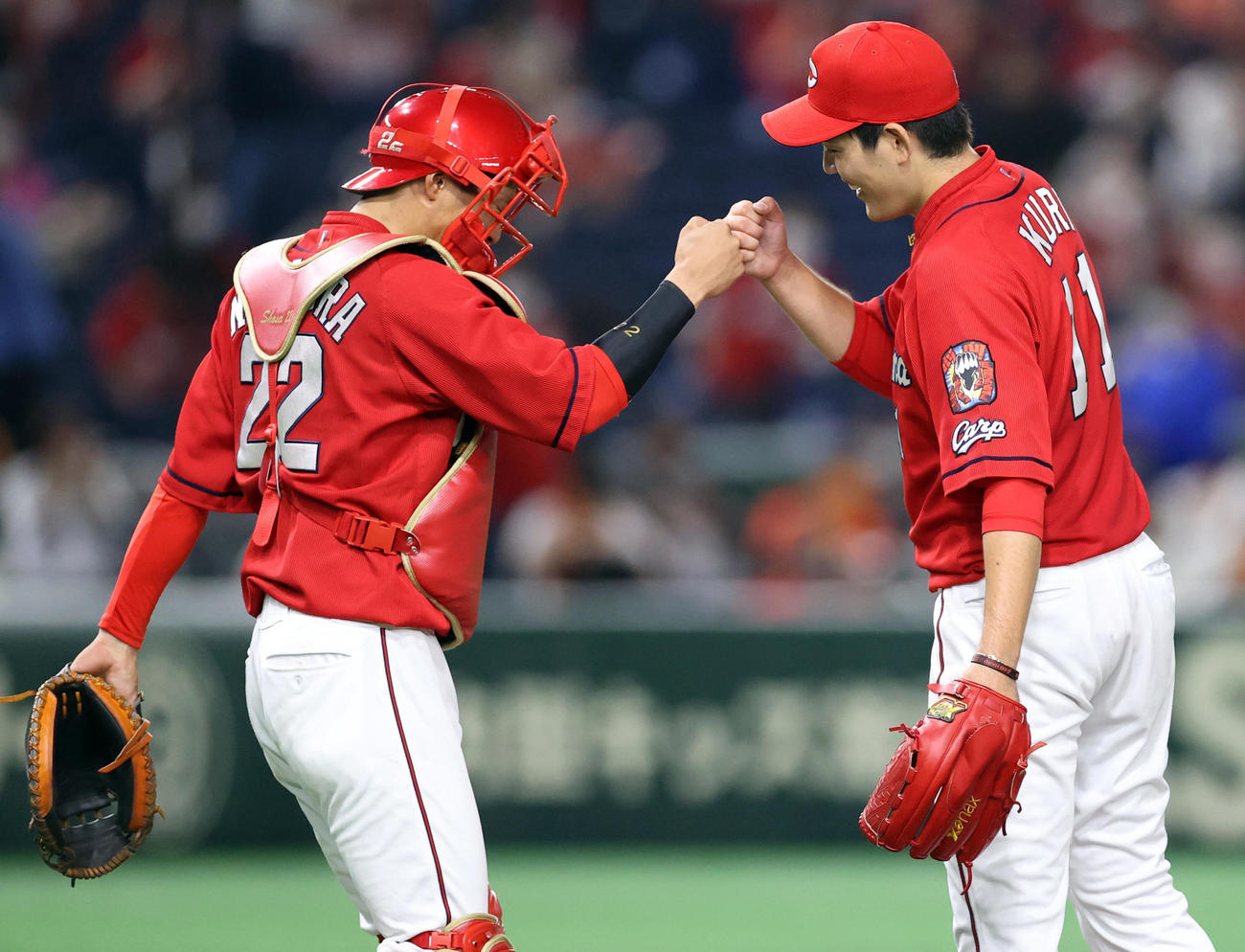 巨人対広島　9回裏巨人2死三塁、最後の打者重信を右飛に打ち取り、九里（右）とタッチを交わす中村奨（撮影・狩俣裕三）