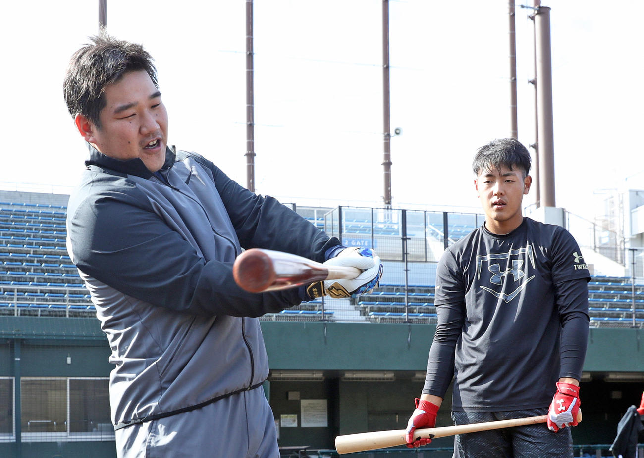 自主トレで西武中村剛也（左）からアドバイスを受ける巨人岡本和真（2017年11月27日撮影）