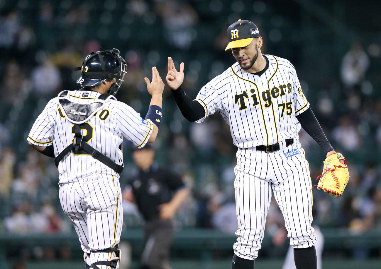 阪神対オリックス　スアレス試合を締め笑顔で捕手梅野とポーズを決める（撮影・上山淳一）