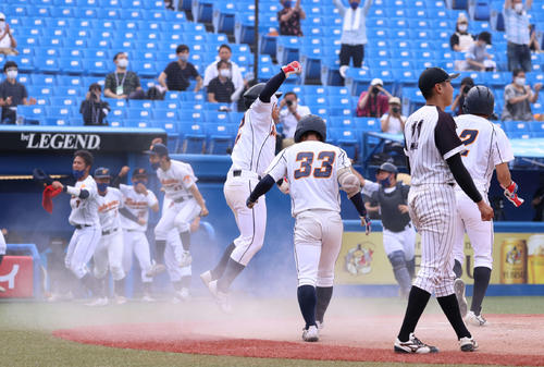九産大対和歌山大 10回裏和歌山大1死満塁、柏田の内野安打で一気にサヨナラの生還を果たしジャンプして喜ぶ二塁走者の島本(中央)(撮影・河野匠)