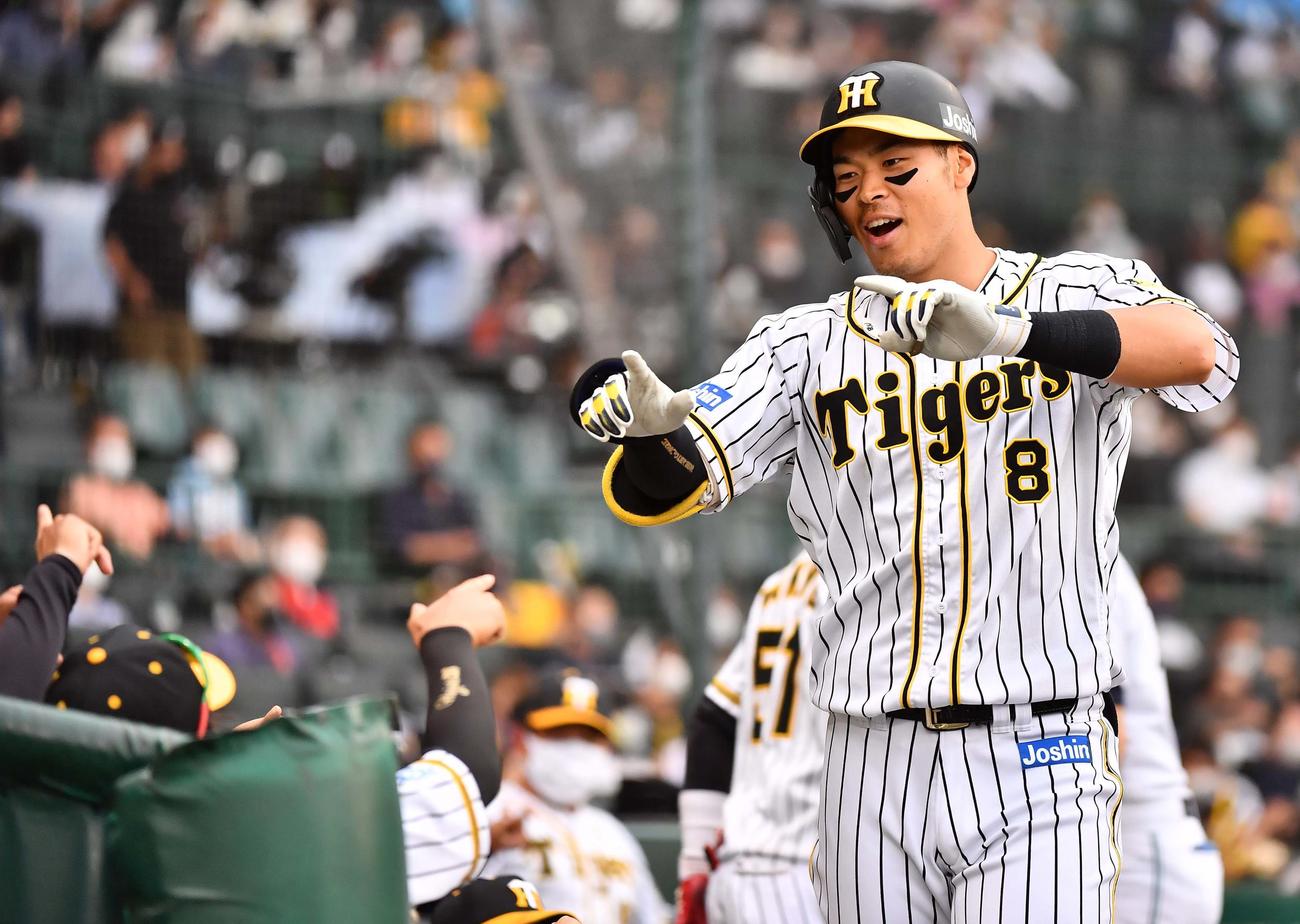 阪神対ソフトバンク　9回裏阪神1死、右中間にソロ本塁打を放った佐藤輝はナインの出迎えに「Zポーズ」で応える（撮影・上田博志）