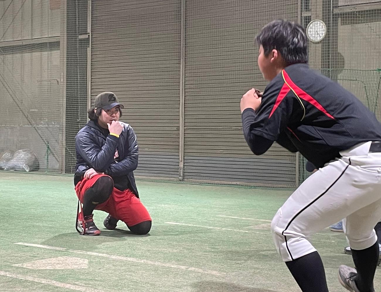 室内練習場で小学生を指導する坂元弥太郎さん（左）＝２０２１年１月20日