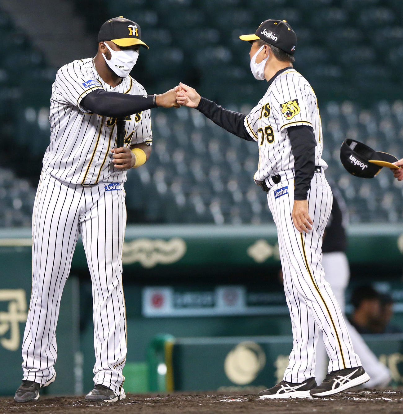 阪神対ソフトバンク　本塁打を放ったロハス・ジュニア（左）はスタンドのファンにあいさつを済まし平田2軍監督とグータッチする（撮影・上山淳一）