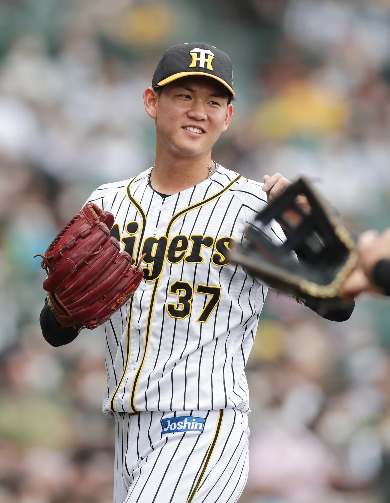 阪神対巨人　7回表の巨人打線を抑え、笑顔を見せながらベンチへ戻る阪神及川（撮影・前田充）