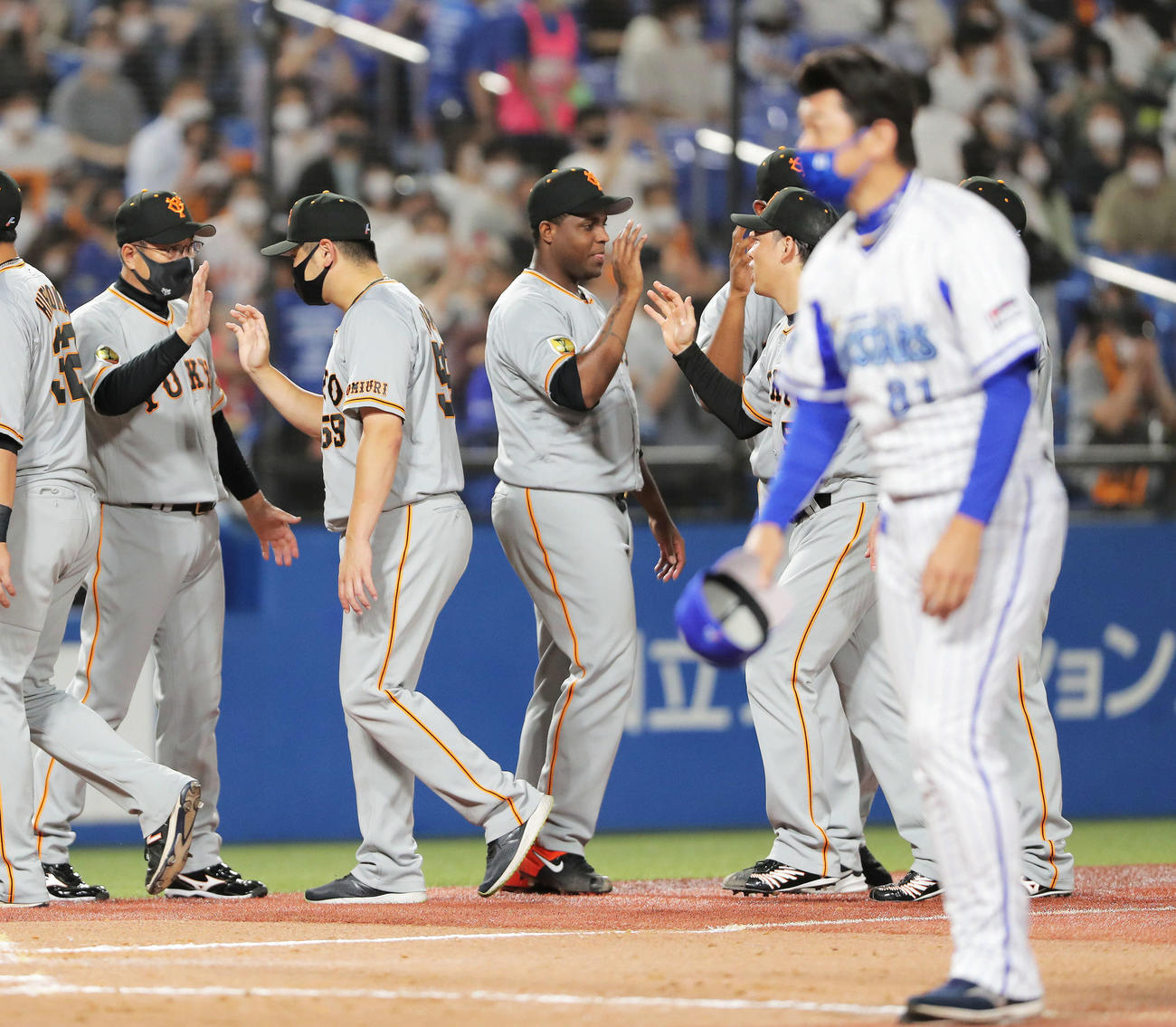 DeNA対巨人　DeNAに勝利し、ナインを迎える原監督（左）。手前は観客にあいさつする三浦監督（撮影・河田真司）