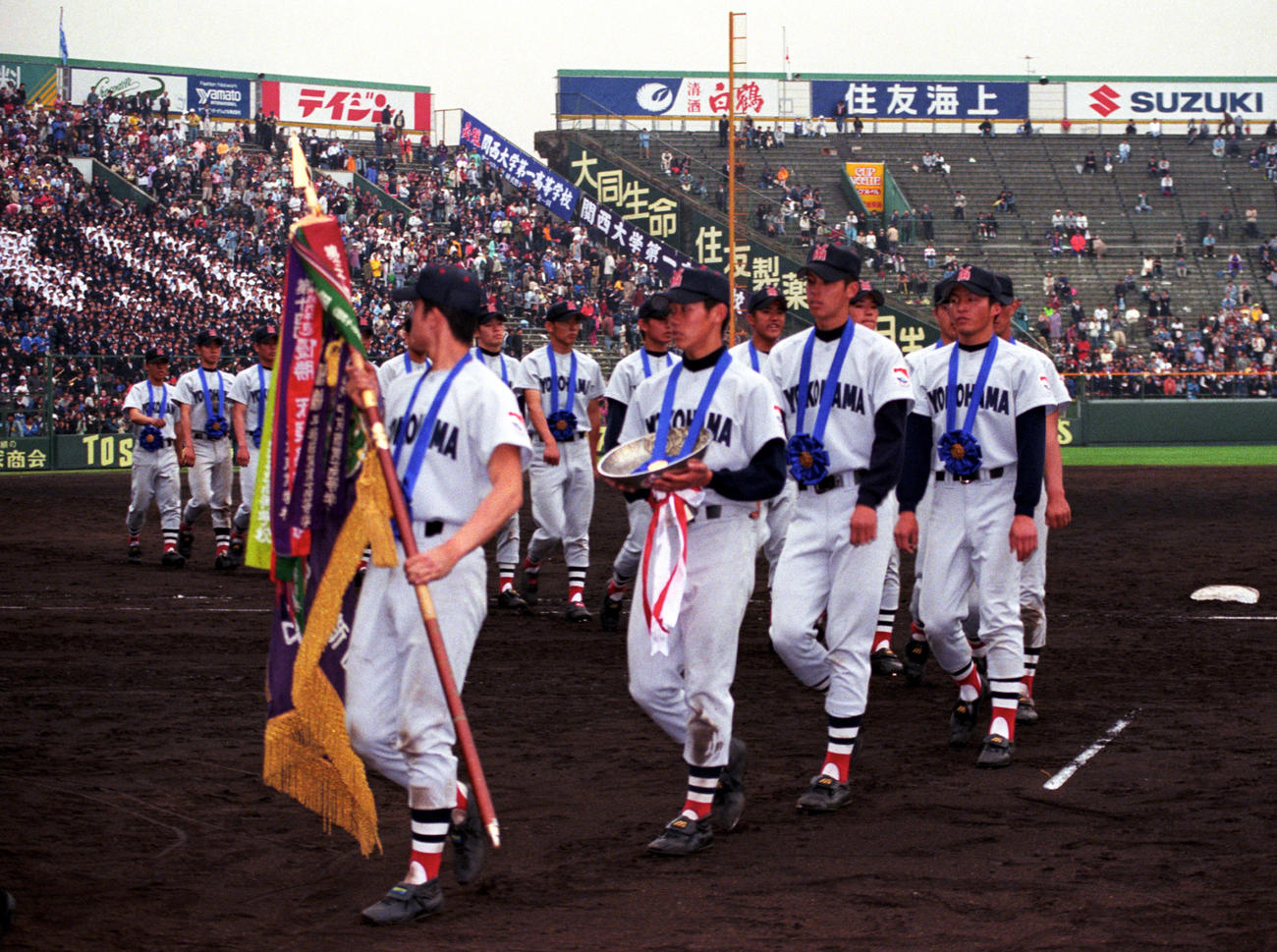 ９８年４月、選抜高校野球で優勝し、行進する横浜ナイン。左から優勝旗を持つキャプテンの小山、優勝盾を持つ松坂