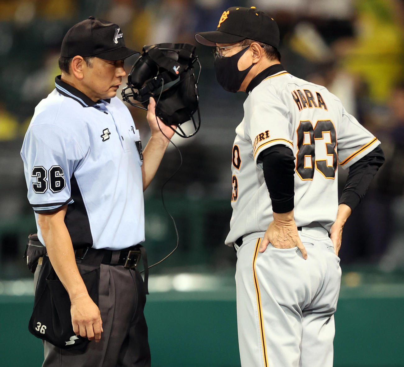 阪神対巨人　7回表途中、降雨により試合続行不能のためコールド負けが決定し、真鍋球審（左）に説明を求める原監督（撮影・狩俣裕三）