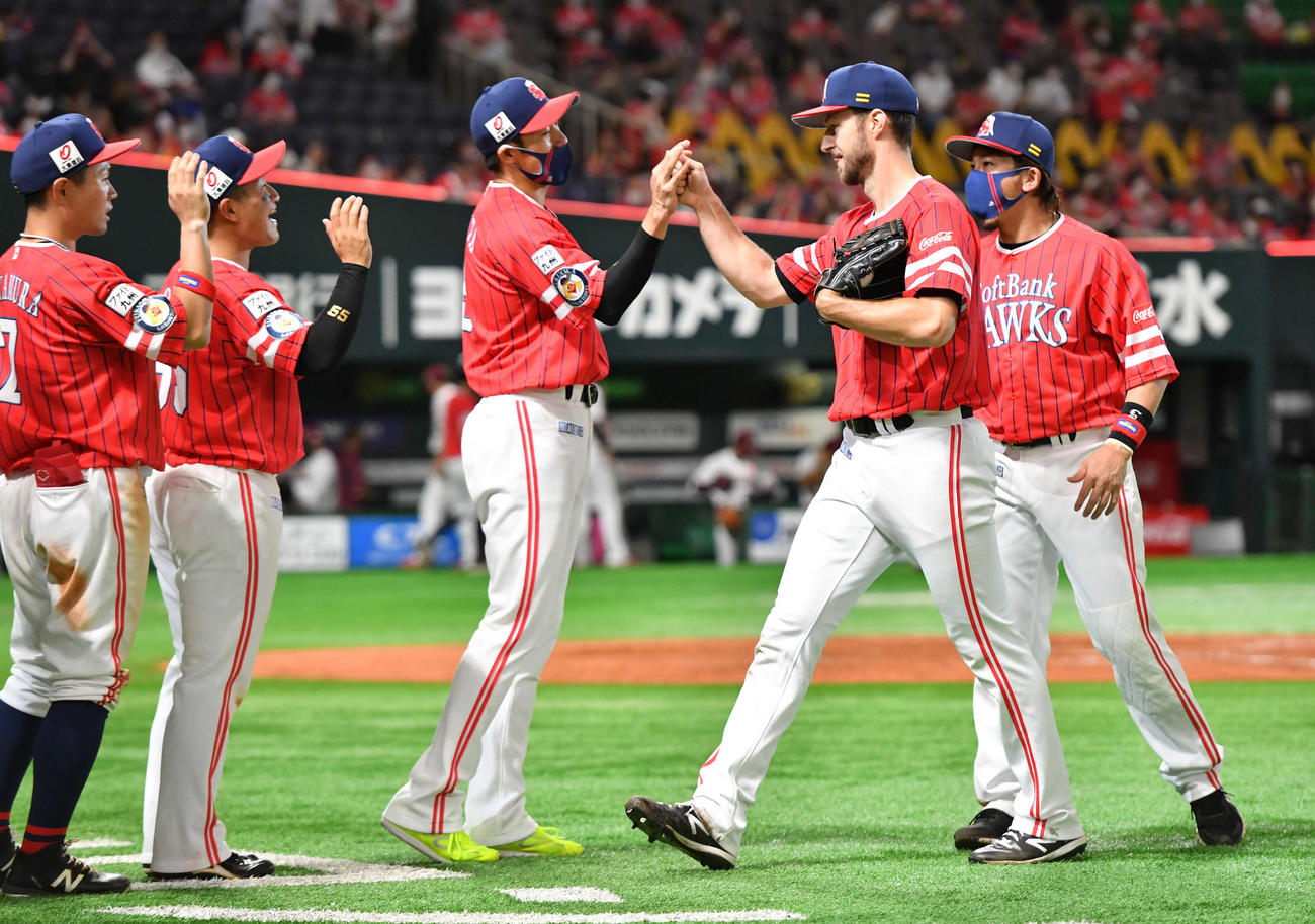 ソフトバンク対楽天　来日初完封勝利し、左から中村晃、野村、柳田とタッチを交わすレイ、右端は松田（撮影・岩下翔太）