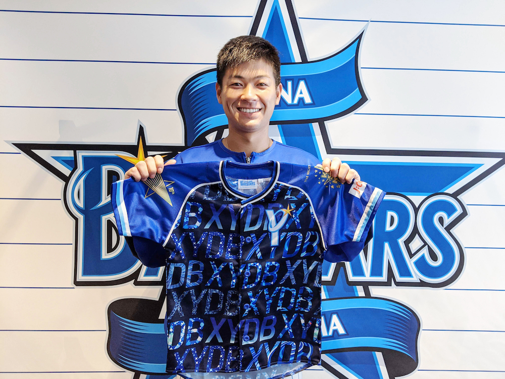DeNAが9月12日阪神戦で配布する子ども用ユニホームを持つ柴田竜拓内野手（球団提供）。「キッズSTAR☆NIGHT 2021 Supported by J:COM」のイベントが行われる