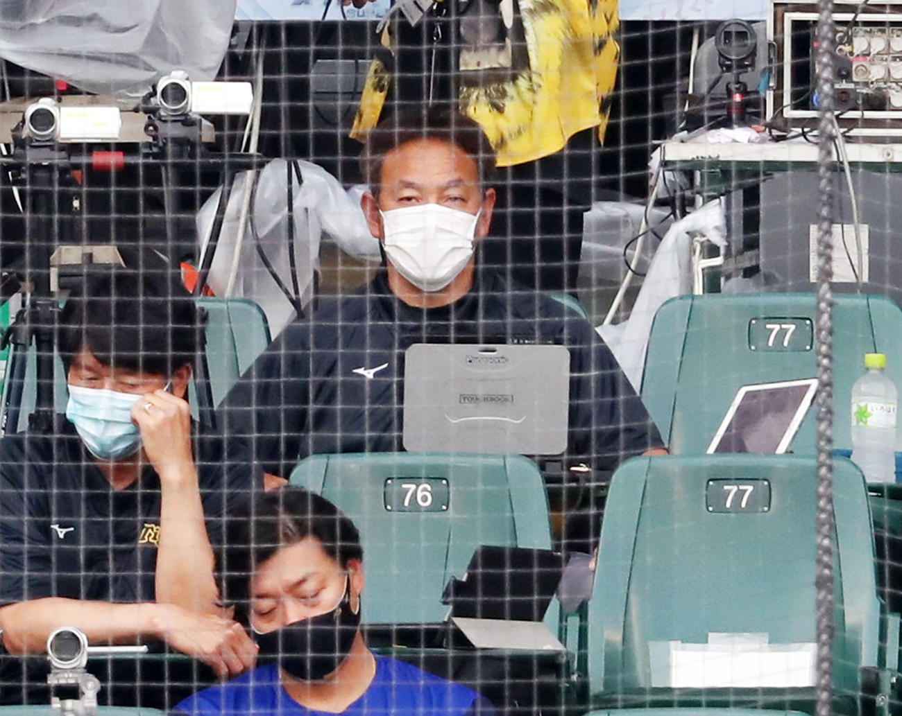 ネット裏から試合を見る阪神谷中真二スコアラー（撮影・加藤哉）