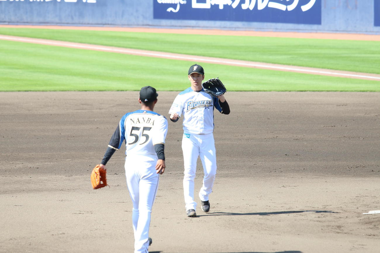 チームメートからボールを受け取る日本ハム斎藤（撮影・田中彩友美）