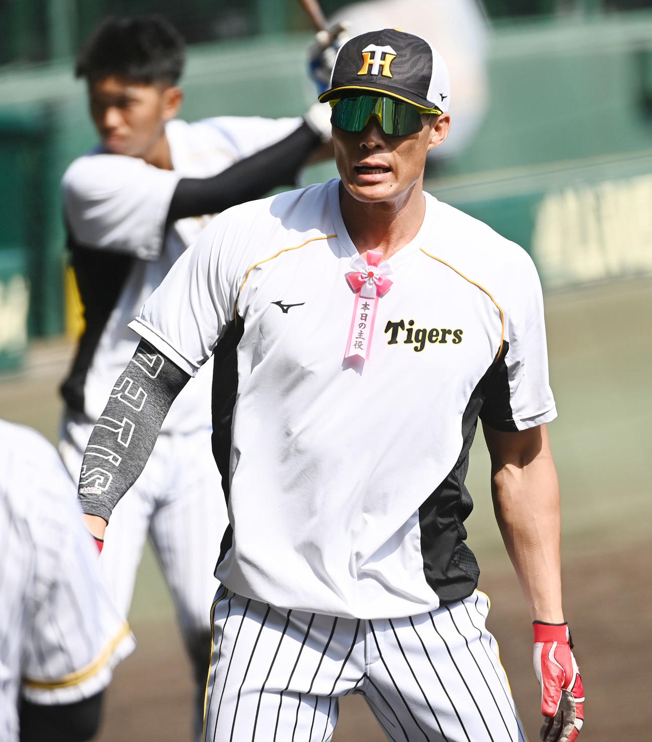 誕生日を迎えた糸井は「本日の主役」のリボンをつけてティー打撃を行う（撮影・前岡正明）