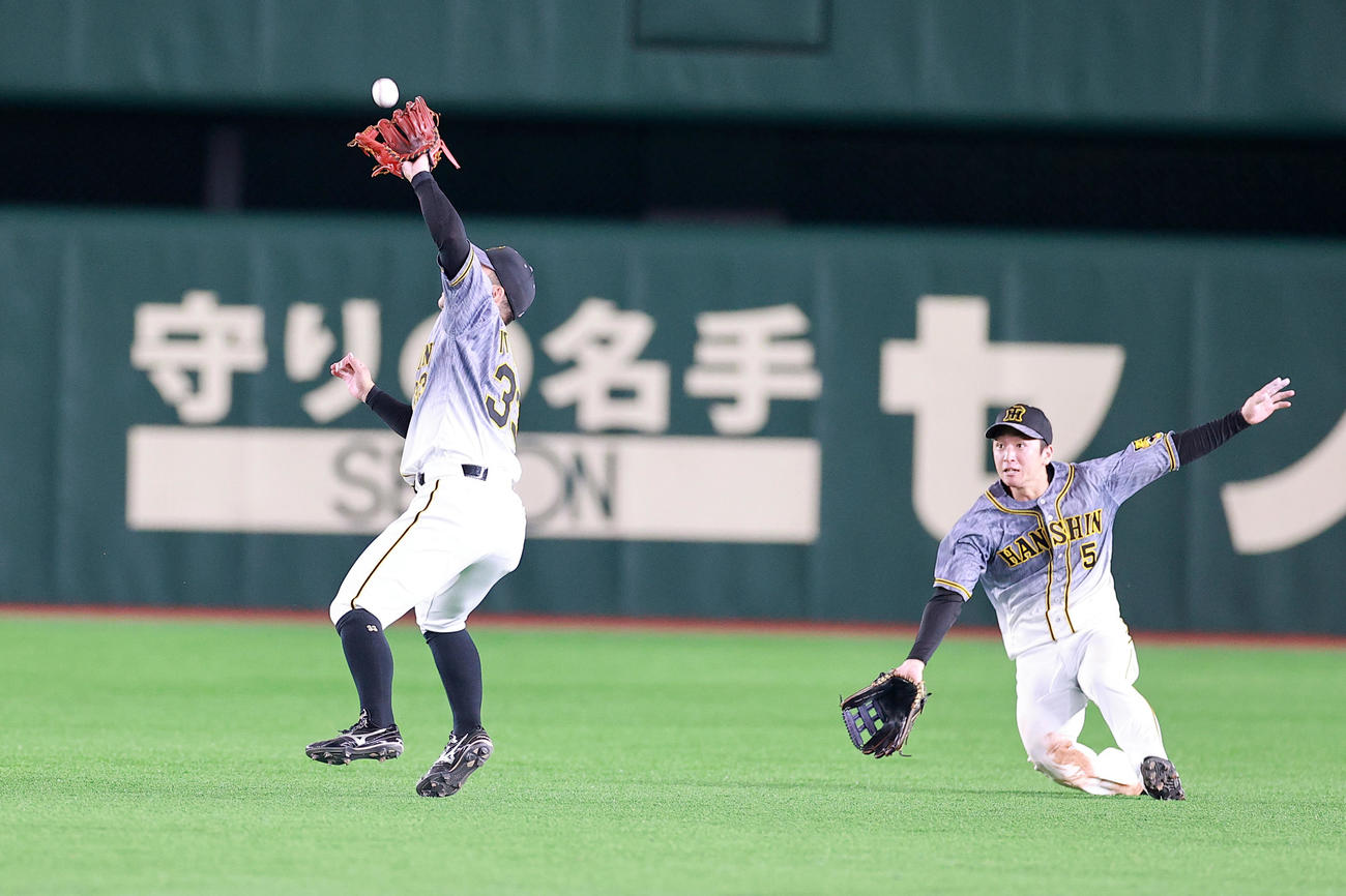 DeNA対阪神　6回裏DeNA2死満塁、宮崎の打球を好捕する糸原（左）。右は近本（撮影・浅見桂子）