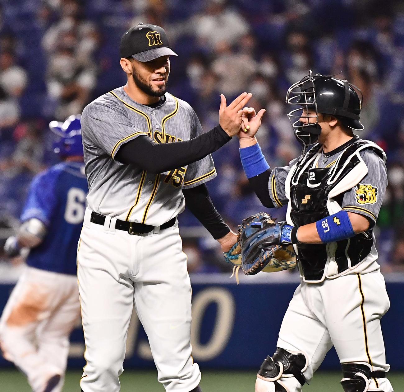 中日対阪神　中日に勝利し、梅野（右）と喜び合うスアレス（撮影・上田博志）