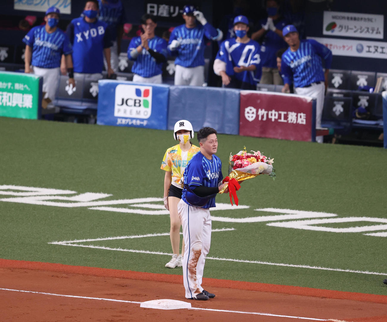 阪神対DeNA 9回表DeNA無死、右翼線へ三塁打を放ちサイクル安打を達成した牧は花束を受け取る（撮影・清水貴仁）