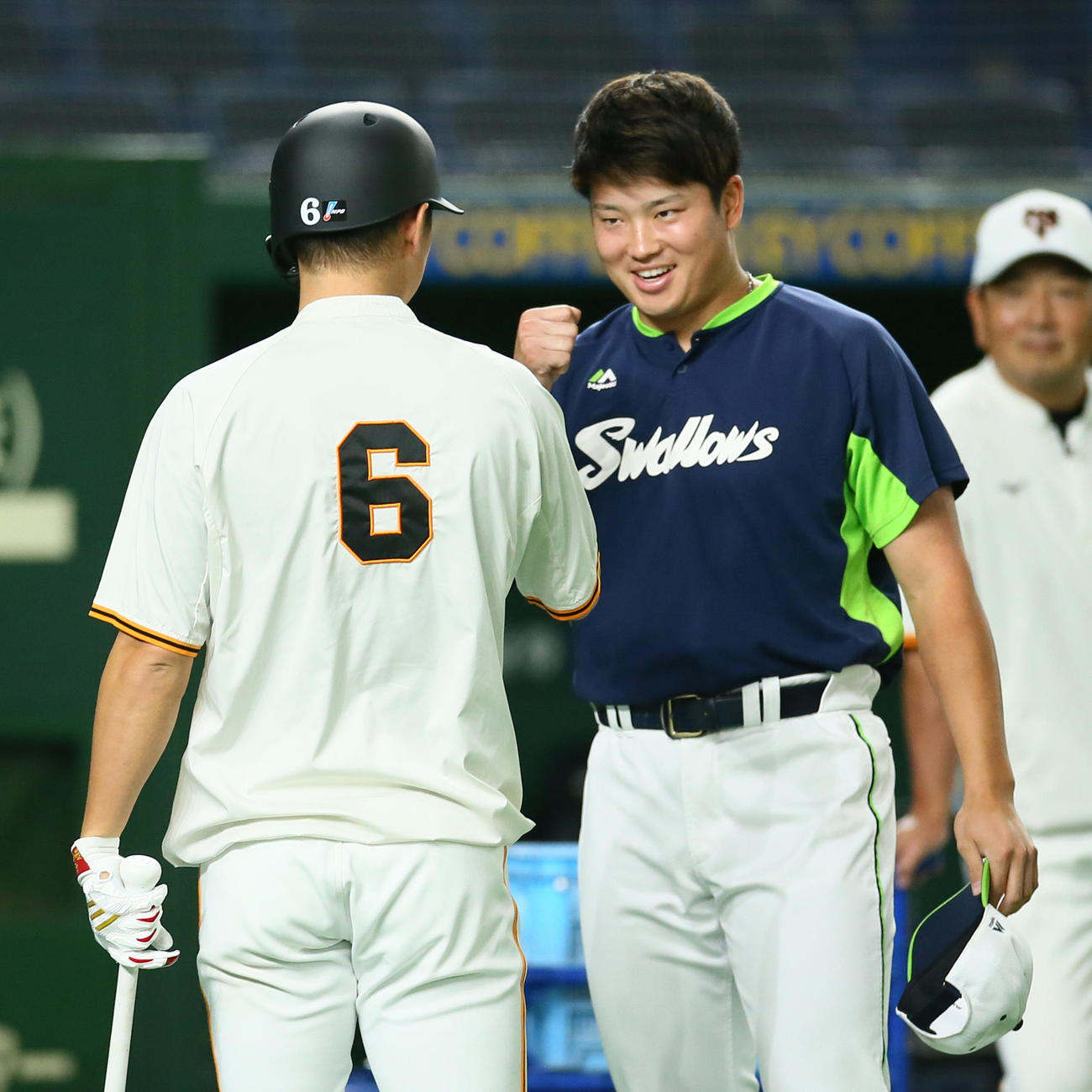 試合前、巨人坂本（左）と笑顔でタッチを交わす村上（21年9月17日撮影）