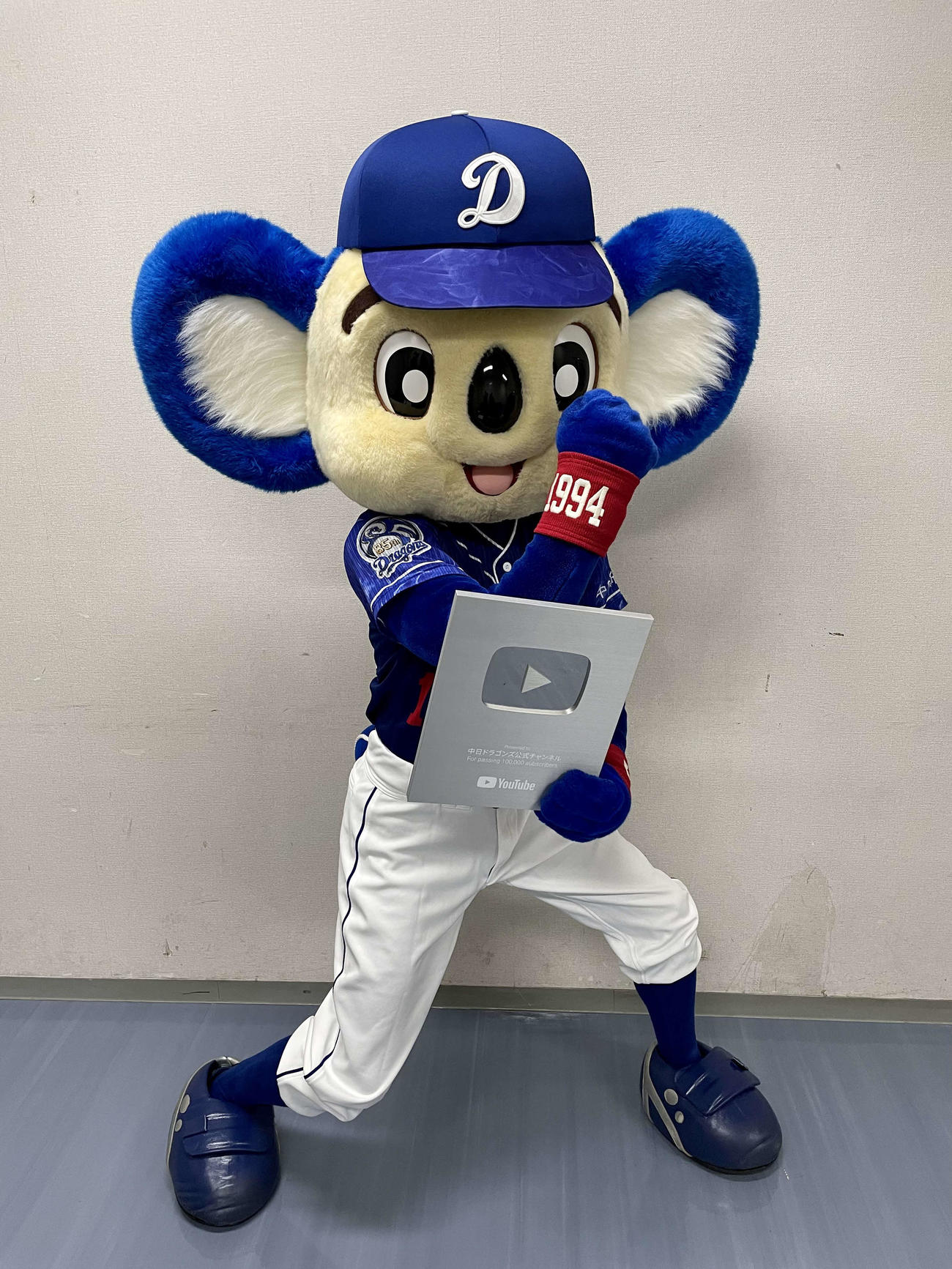 YouTubeから贈呈された銀の盾を持ちポーズを決めるドアラ（球団提供）