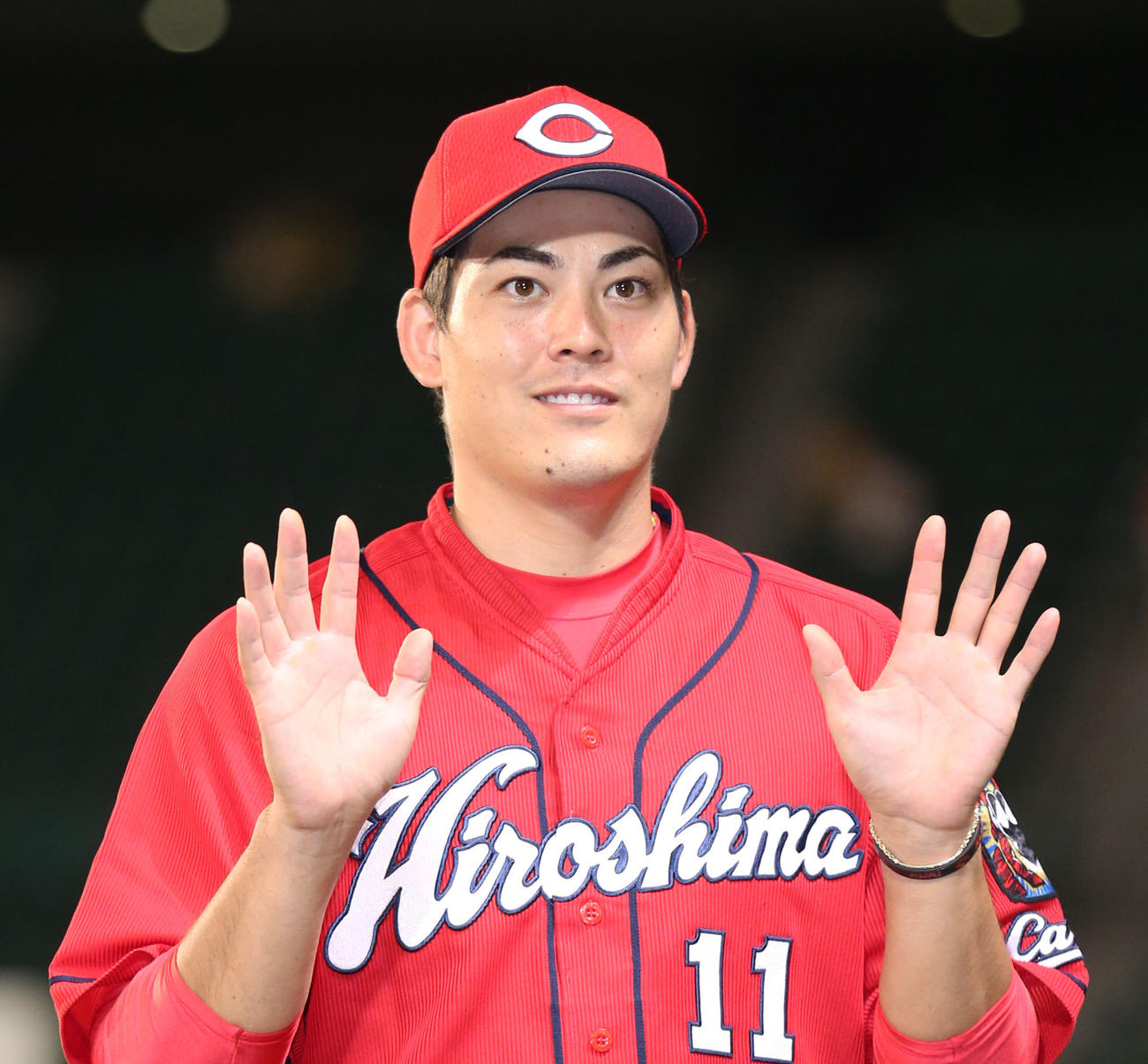 阪神対広島　10勝目を挙げた広島九里は笑顔で記念撮影に応じる（撮影・上山淳一）