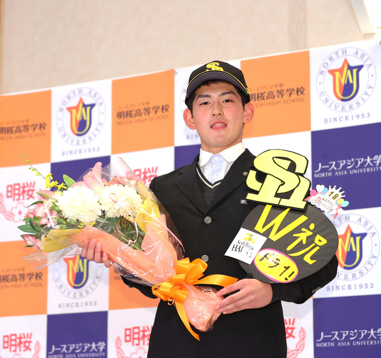 ソフトバンクの1位指名を受けこの日誕生日のノースアジア大明桜・風間は贈られた花束を手に笑顔で写真に納まる（撮影・垰建太）