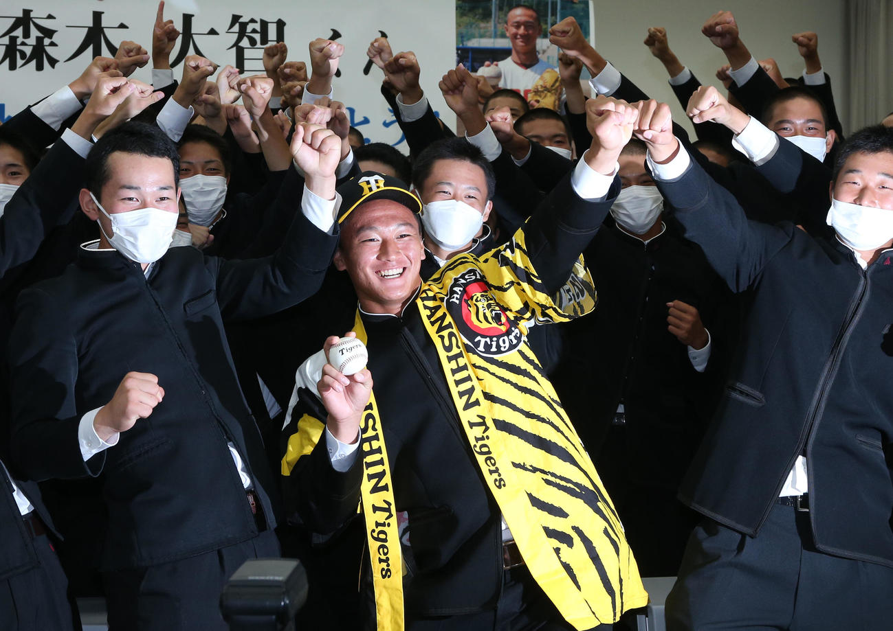 高知の森木（中央）は阪神1位指名を受け、仲間たちとポーズを決める（撮影・上山淳一）